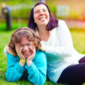 two women smiling outdoors